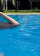 A woman's legs in the water of a swimming pool.