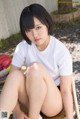 A woman sitting on top of a wooden chair.