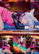 A woman in a bunny costume is playing pool.